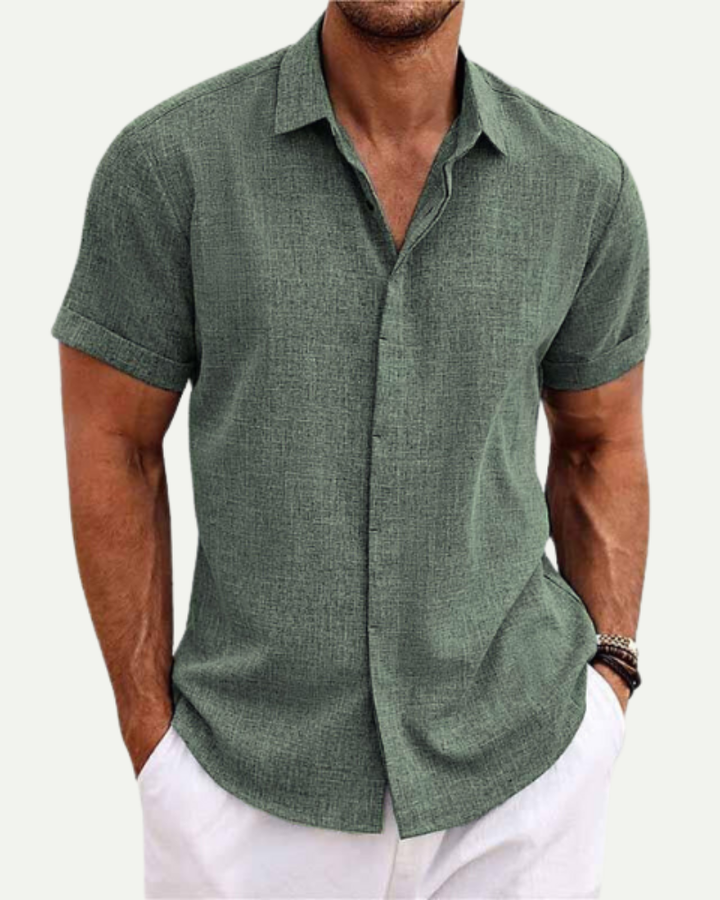 Man wearing a green short-sleeve shirt on a white background