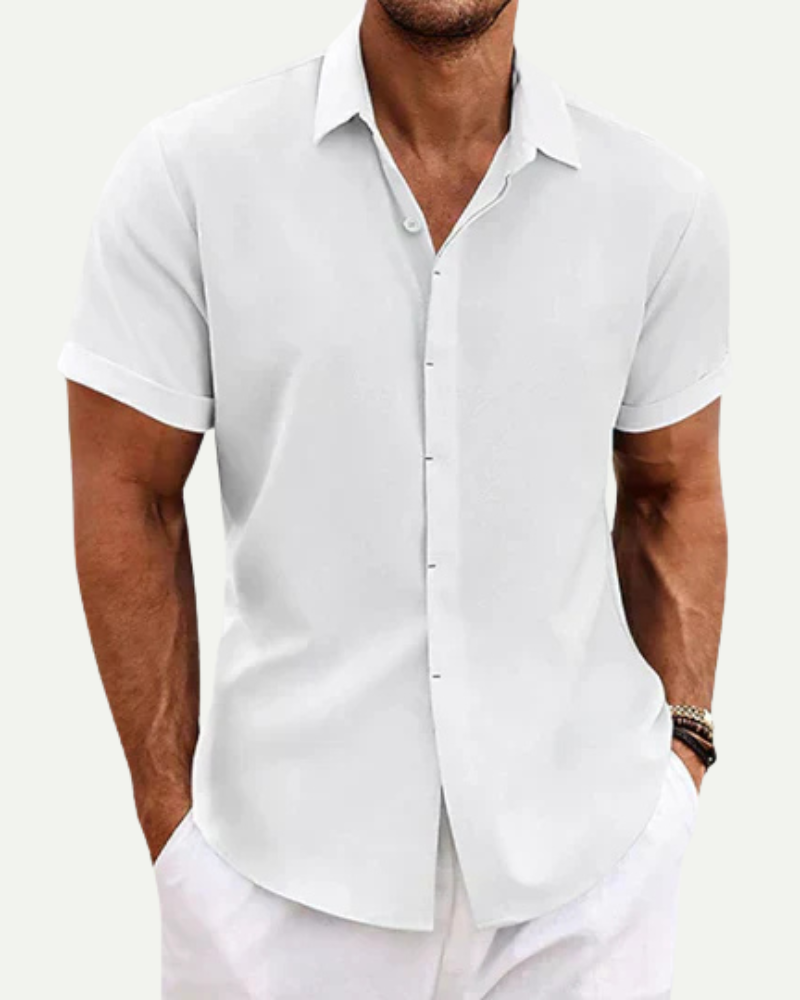 Man wearing a white short-sleeve shirt against a white background